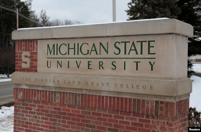 FILE: A sign for Michigan State University is seen near the campus in East Lansing, Michigan, Feb. 1, 2018.