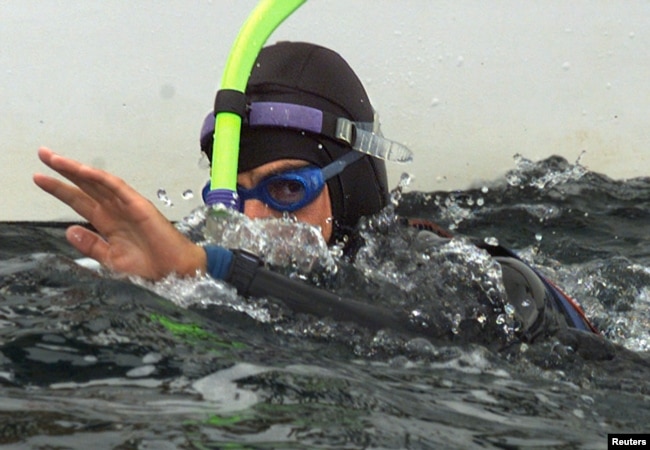 FILE - French swimmer Benoit Lecomte swims off the Brittany port of Quiberon at the end of his trans-Atlantic swim, September 25. Ben Lecomte left Cape Cod on July 16 to undertake the 5,400 kilometer swim aided by a yacht.