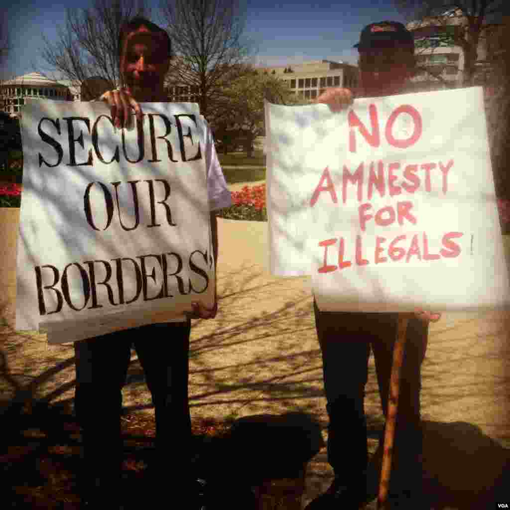 Thomas Bowie of Maryland and Jim MacDonald, a member of the New Yorkers for Immigration Control and Enforcement group, stand in protest of the pro-immigration reform rally in Washington, DC, on Wednesday, April 10, 2013. (Photo by Kate Woodsome)