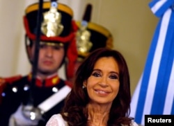 FILE - Argentina's President Cristina Fernandez de Kirchner smiles during a ceremony on her last day in office at the Casa Rosada Presidential Palace in Buenos Aires, Argentina, Dec. 9, 2015.
