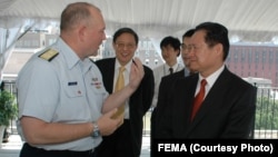 FILE - U.S. Admiral Thad Allen speaks with former Chinese Minister of Public Security Zhou Yongkang in 2006.