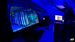  A member of the Cybercrime Center turns on the light in a lab during a media tour at the occasion of the official opening of the Cybercrime Center at Europol headquarters in The Hague, Netherlands, Friday Jan. 11, 2013.