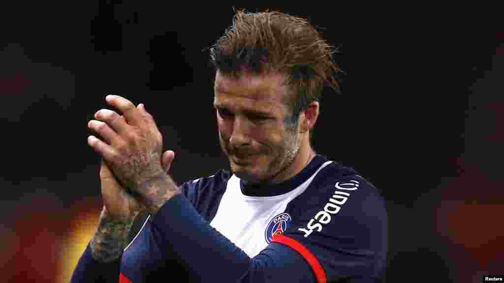 Paris Saint-Germain's David Beckham breaks down in tears as he leaves the pitch after being substituted in the 81st minute during his team's French Ligue 1 soccer match against Brest, May 18, 2013.