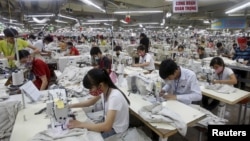 FILE - Laborers work at a garment factory in Bac Giang province, near Hanoi, Oct. 21, 2015. Vietnam's textiles and footwear are expected to gain strongly from the Trans-Pacific Partnership, after exports of $31 billion in 2014 for brands such as Nike, Adidas and H&M.