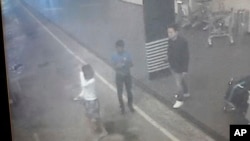 This image provided by Star TV, Feb. 15, 2017, of closed circuit television footage from Monday, Feb 13, 2017, shows a woman (left) at Kuala Lumpur International Airport in Sepang, Malaysia, who police say was arrested in connection with the death of Kim Jong Nam, the half brother of North Korean leader Kim Jong Un. (Star TV via AP)