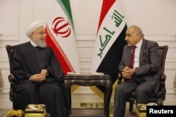 Iraq's Prime Minister Adel Abdul Mahdi meets Iranian President Hassan Rouhani in Baghdad, Iraq March 11, 2019.