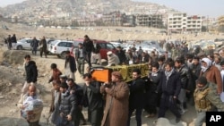 FILE - Men carry the coffin of a relative who died in the Jan. 27 deadly suicide attack in Kabul, Afghanistan. At a recent Senate hearing on top U.S. security threats, the word “Afghanistan” was spoken exactly four times, and in two hours, no senator asked about Afghanistan.
