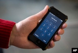 FILE - An iPhone is seen in an illustration photo taken Feb. 17, 2016, in Washington, D.C. In the case of the December 2015 San Bernardino shooting, the FBI was able to decrypt the suspect's phone on its own but has been unable to do so with a device that was owned by the Texas church shooter.