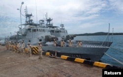 FILE - Sailors stand guard near patrol boats at the Cambodian Ream Naval Base in Sihanoukville, Cambodia, July 26, 2019. (REUTERS/Samrang Pring)