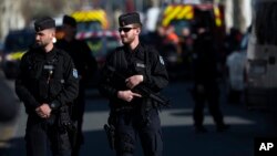 Des policiers montent le garde après l'attaque contre un supermarché de Trèbes dans le sud de la France, le 23 mars 2018 