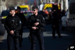 French police officers cordon off the area around a terrorist attack in Trebes, southern France, March 23, 2018.