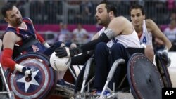 Jason Regier, left, of the United States goes for the ball with Nicholas Rioux of France