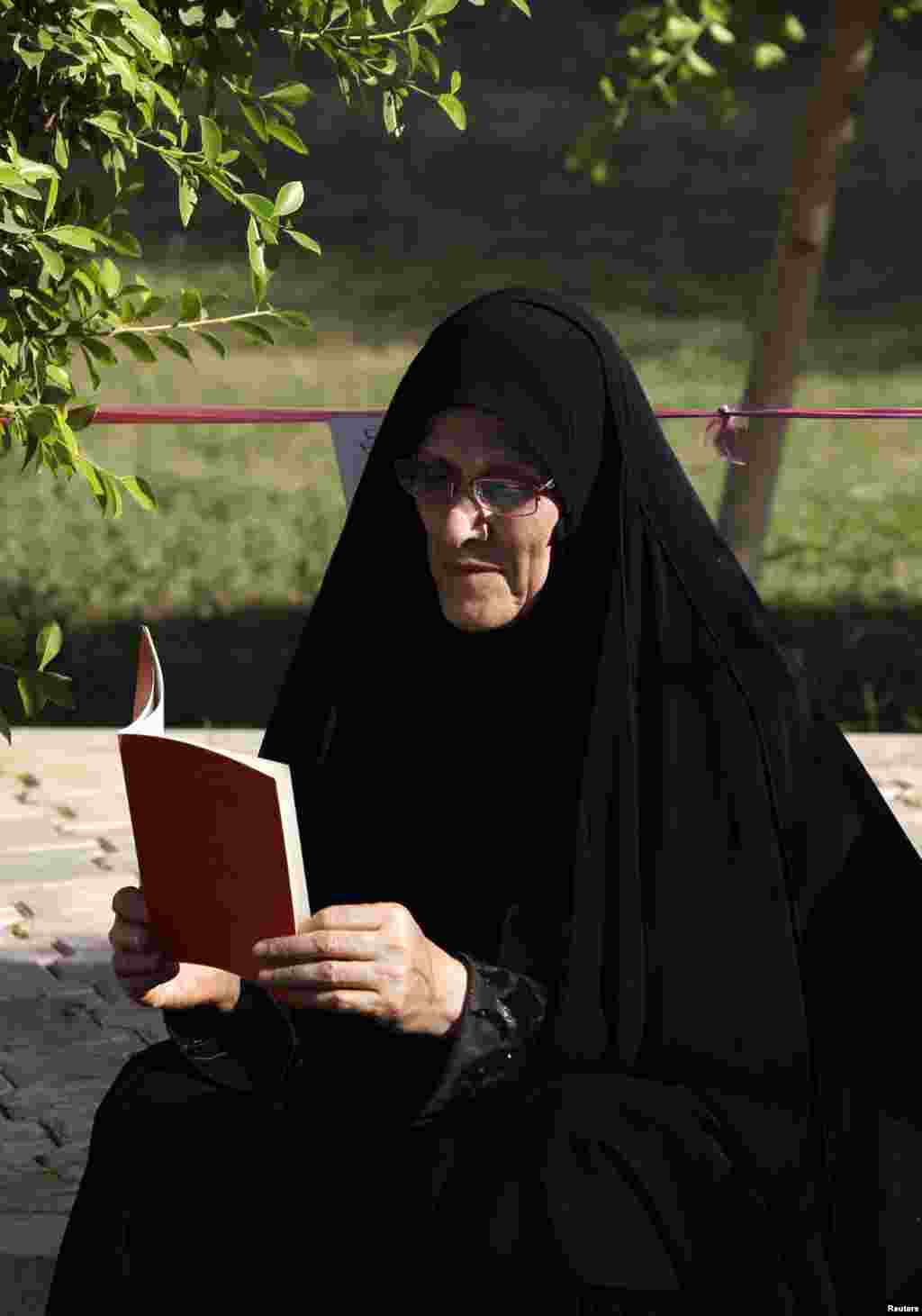 A woman reads during the launch of a reading initiative in Baghdad September 29, 2012. 