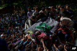 Kashmiri villagers carry body of rebel leader Sabzar Ahmed Bhat during his funeral procession in Retsuna, 45 kilometers south of Srinagar, May 28, 2017.