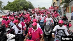 Supporters of Maldivian President Abdulla Yameen ride on their bikes during the final campaign march rally ahead of the presidential election in Male, Maldives, Sept. 22, 2018. 