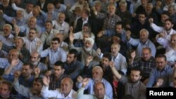 FILE - Iranian worshippers chant slogans against Bahraini regime and Saudi Arabia during Friday prayers in Tehran, Iran, May 26, 2017.