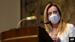 FILE: Leader of Brothers of Italy party, Giorgia Meloni, addresses the media after meeting Mario Draghi, at the Chamber of Deputies in Rome, Feb. 5, 2021