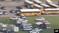 In this image taken from video law enforcement officers respond to a high school near Houston after an active shooter was reported on campus in Santa Fe, Texas, May 18, 2018.