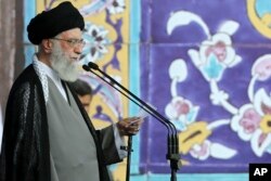 Supreme Leader Ayatollah Ali Khamenei delivers his sermon during the Eid al-Fitr prayer at the Imam Khomeini Grand Mosque in Tehran, Iran, in this photo released by his office's website, July 18, 2015.