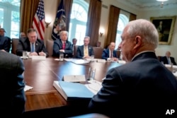 President Donald Trump, second from left, listens as Attorney General Jeff Sessions, right, speaks during a cabinet meeting in the Cabinet Room of the White House, Aug. 16, 2018, in Washington.