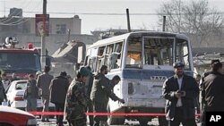 A damaged minibus is seen at the scene after it was attacked by a suicide attacker in Kabul, Afghanistan, 12 Jan 2011