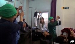 This frame grab from video provided by the Hawar News Agency shows people wounded in an attack by the Islamic State group receiving treatment at a clinic in al-Hasakah province, Syria, May 2, 2017.