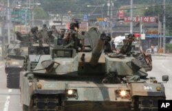 South Korean army soldiers ride K-1 tanks during an annual exercise in Paju, South Korea, near the border with North Korea, July 5, 2017.