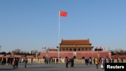 FILE - A Chinese flag flutters against the blue sky in Tiananmen Square in Beijing, China, Dec. 24, 2017. 