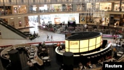 FILE - Customers dine at Armani Caffe in Dubai Mall in June 2012. A planned ‘Mall of the World’ there would be the largest to date. 