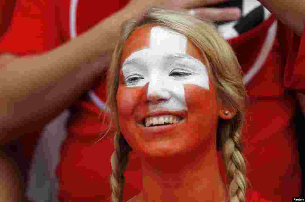 A Switzerland fan smiles while attending their men's Group B football match against South Korea in the London 2012 Olympic Games at the City of Coventry stadium July 29, 2012. 