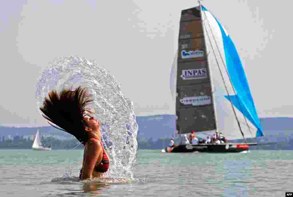 A woman cools down in Lake Balaton near Budapest during a heatwave in Hungary. REUTERS/Laszlo Balogh