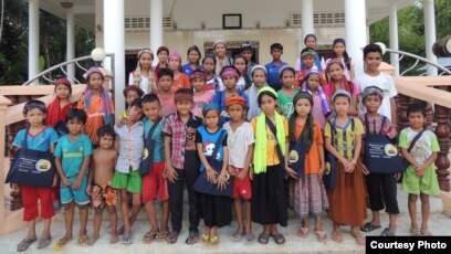 Young Cham muslim children stand in front of an informal classroom for Cham language and script learning. (Courtesy photo of Leb Ke)