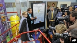 France's Ecology, Transport and Housing Minister Nathalie Kosciusko-Morizet (L) visits the French Alternative Energies and Atomic Energy Commission CEA in Gif-sur-Yvette near Paris, June 7, 2011