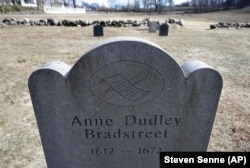 This Tuesday, March 19, 2019, photo, shows a commemorative marker for 17th century American poet Anne Bradstreet at an old burial ground, in North Andover, Massachusetts.