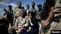 Yazidi survivor and U.N. Goodwill Ambassador for the Dignity of Survivors of Human trafficking Nadia Murad, center, visits her village for the first time after being captured and sold as a slave by the Islamic State three years ago, in Kojo, Iraq, June 1, 2017.