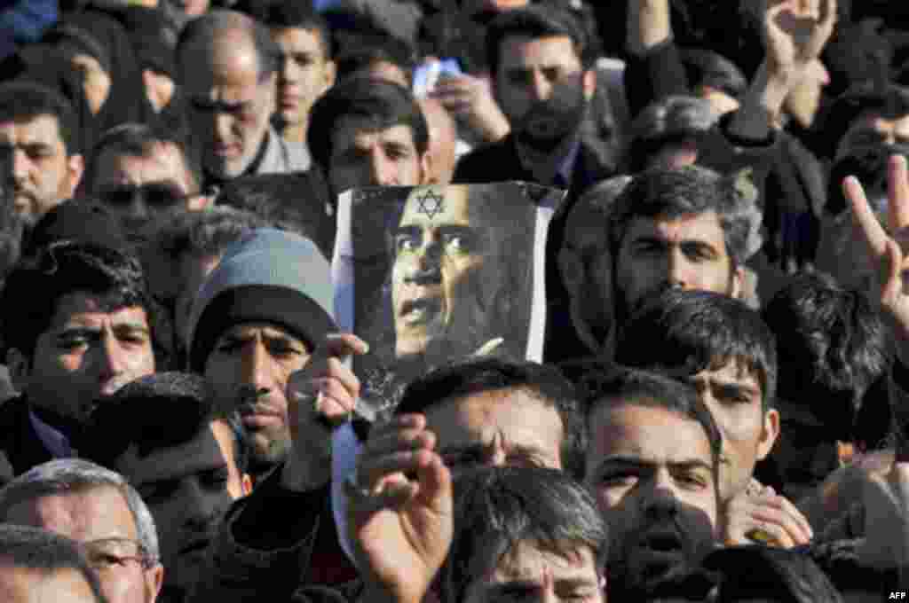 A poster against US President Barack Obama is held during a funeral ceremony of Mostafa Ahmadi Roshan, on Friday, Jan. 13, 2012, a chemistry expert and a director of the Natanz uranium enrichment facility in central Iran, who was killed in a brazen daylig