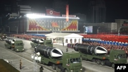 This picture taken on January 14, 2021 and released from North Korea's official Korean Central News Agency (KCNA) on January 15 shows what appears to be submarine-launched ballistic missiles during a military parade celebrating the 8th Congress of the Wor