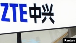 FILE- A sign for the ZTE booth is seen at the Mobile World Congress, the world's largest mobile phone trade show in Barcelona, Spain, Feb. 26, 2014.