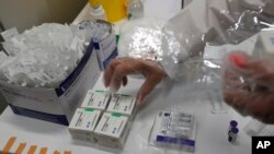 Document-Un trabajador médico prepara un vial de vacuna COVID-19 en el Centro de Vacunas en Belgrado, Serbia, China Sinopharm Group, Sputnik V, Centro y Pfizer de la izquierda el 6 de mayo de 2021.