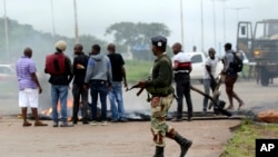 Un soldat veille à l'enlèvement d'une barricade alors que les manifestants se rassemblaient pour manifester contre la hausse du prix du carburant à Harare, au Zimbabwe, mardi 15 janvier 2019. (Photo AP / Tsvangirayi Mukwazhi)