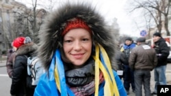 Maria, a physician, attends a rally in downtown Kyiv, Ukraine, Dec. 4, 2013. 