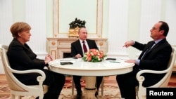 German Chancellor Angela Merkel and Russia's President Vladimir Putin (C) listen to French President Francois Hollande during a meeting on resolving the Ukraine crisis at the Kremlin in Moscow February 6, 2015.