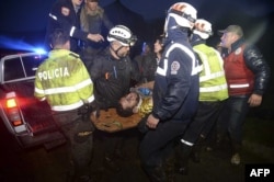 Rescuers carry one of the survivors from the LAMIA airlines charter plane carrying members of the Chapecoense Real football team that crashed in the mountains of Cerro Gordo, municipality of La Union, Nov. 29, 2016.