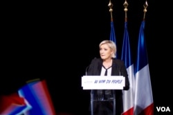 French far-right presidential candidate speaks in an auditorium in Monswiller, Alsace, where her tough anti-immigrantion helps swell her ranks of supporters. (R. James/VOA)