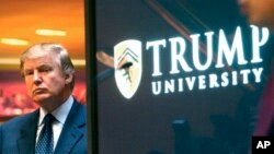 A class-action lawsuit involving President-elect Donald Trump, shown during unveiling of the now-defunct Trump University, May 23, 2005, is expected to start November 28. 