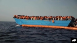 Migrants are crowded on to the vessel in the Mediterranean Sea off the coast of Libya in this Tuesday Oct. 4, 2016 image taken from video. 