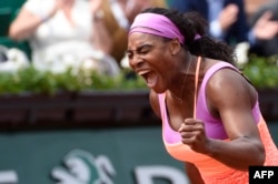 FILE - Serena Williams celebrates after winning her match against Germany's Anna-Lena Friedsam during the women's second round of the Roland Garros 2015 French Tennis Open in Paris on May 28, 2015.