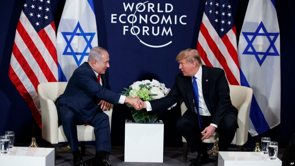 President Donald Trump shakes hands with Israeli Prime Minister Benjamin Netanyahu during a meeting at the World Economic Forum, Jan. 25, 2018, in Davos, Switzerland.
