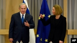 Israeli Prime Minister Benjamin Netanyahu, left, speaks with European Union High Representative Federica Mogherini during a bilateral meeting at the EU Council building in Brussels on Monday, Dec. 11, 2017.