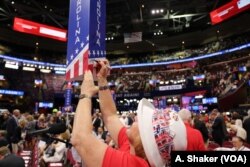 Delegates make their mark on state placards at the Republican National Convention, in Cleveland, July 21, 2016.